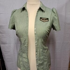 Green blouse (shown on a dummy unbuttoned) with short sleeves, collar, and army badge on the left breast