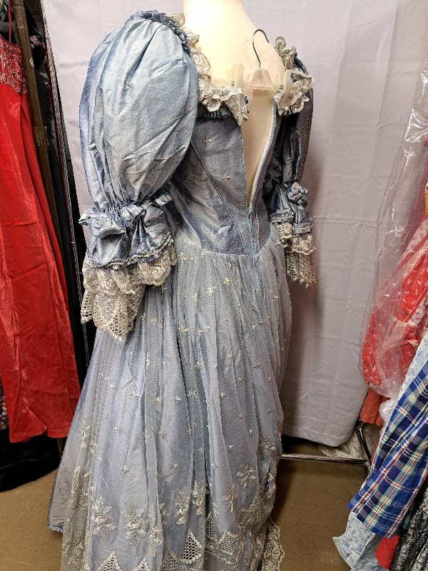 Women's pale blue silk lace dress shown on a dressmaker's dummy. Lace detail on the neckline and gathered cuffs